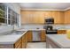Bright kitchen featuring light wood cabinets, stainless steel appliances, and a large window at 109 Troyer Pl, Apex, NC 27502