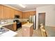 Well-lit kitchen featuring stainless steel appliances, ample counter space, wooden cabinets and a central island at 109 Troyer Pl, Apex, NC 27502