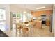 Bright eat-in kitchen features stainless steel appliances, a breakfast bar, and sliding glass doors to outside at 109 Troyer Pl, Apex, NC 27502