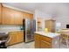 Bright kitchen features stainless steel refrigerator, wood cabinets, and a functional island at 109 Troyer Pl, Apex, NC 27502
