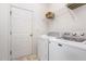 Practical laundry room featuring a white washer, dryer, and a storage shelf above at 109 Troyer Pl, Apex, NC 27502
