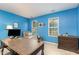 Bright office featuring a large desk, daybed, and stylish decor with two windows for natural light at 109 Troyer Pl, Apex, NC 27502