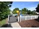 A modern playground is enclosed by a white fence in a green community at 109 Troyer Pl, Apex, NC 27502