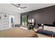 This modern bedroom features a ceiling fan and sliding glass doors leading to the outside at 1115 Sepelo Way, Efland, NC 27243