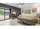 Modern bedroom features sliding glass doors, a ceiling fan, and an ensuite sitting area at 1115 Sepelo Way, Efland, NC 27243