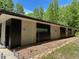 Modern home exterior featuring clean lines, neutral colors, and natural landscaping against a wooded backdrop at 1115 Sepelo Way, Efland, NC 27243