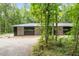 Secluded modern house surrounded by tall, lush trees at 1115 Sepelo Way, Efland, NC 27243
