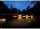 Stunning modern exterior featuring sleek lines, enhanced by landscape lighting and a metal roof at twilight at 1115 Sepelo Way, Efland, NC 27243