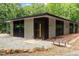A modern home featuring a stone entryway with a wooden bridge at 1115 Sepelo Way, Efland, NC 27243