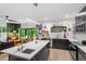 Open-concept kitchen featuring a large island, stainless appliances, and seamless connection to the living area at 1115 Sepelo Way, Efland, NC 27243