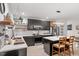 Modern kitchen featuring stainless steel appliances, a center island with seating, and custom dark cabinetry at 1115 Sepelo Way, Efland, NC 27243