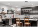 Contemporary kitchen featuring black cabinets, subway tile backsplash, and a stylish island with seating at 1115 Sepelo Way, Efland, NC 27243