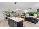 Spacious living room featuring large windows, an island, and modern decor at 1115 Sepelo Way, Efland, NC 27243