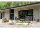 Modern patio with outdoor seating, sliding glass doors, and stylish details of the contemporary house at 1115 Sepelo Way, Efland, NC 27243