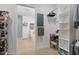 A bright walk-in closet leads to the modern bathroom with blue tiles and a soaking tub at 1115 Sepelo Way, Efland, NC 27243