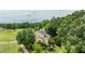 Aerial view of the home's backyard, backing to a golf course, and surrounded by mature trees at 112 Lancaster Dr, Chapel Hill, NC 27517