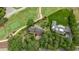 Aerial view of a luxurious home and golf course, surrounded by mature trees at 112 Lancaster Dr, Chapel Hill, NC 27517