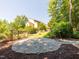 A secluded patio area with stone pavers and lush landscaping for relaxation and entertaining at 112 Lancaster Dr, Chapel Hill, NC 27517