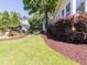 A beautifully landscaped backyard with a deck and mature trees provides privacy and charm at 112 Lancaster Dr, Chapel Hill, NC 27517