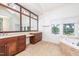 Bathroom features dual vanities and a large soaking tub with views at 112 Lancaster Dr, Chapel Hill, NC 27517