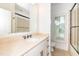 Bright bathroom with a marble countertop, ceramic tile shower, and natural light at 112 Lancaster Dr, Chapel Hill, NC 27517