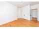 Bedroom featuring hardwood floors, ample light, and a double door closet at 112 Lancaster Dr, Chapel Hill, NC 27517