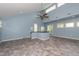 Bright bonus room featuring a ceiling fan, skylights, and a small bar area at 112 Lancaster Dr, Chapel Hill, NC 27517