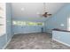 Bright bonus room featuring a ceiling fan, skylights, and built-in shelving at 112 Lancaster Dr, Chapel Hill, NC 27517