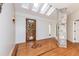 Elegant entryway featuring skylights, decorative wood floors, and a stone accent wall at 112 Lancaster Dr, Chapel Hill, NC 27517