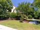 Landscaped front yard with manicured bushes and a charming stone path leading to the home at 112 Lancaster Dr, Chapel Hill, NC 27517