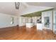 Open-concept kitchen with a large island, stainless steel appliances, custom cabinets, and hardwood flooring at 112 Lancaster Dr, Chapel Hill, NC 27517