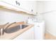 Laundry room featuring a sink, cabinets, countertops, and a washer and dryer at 112 Lancaster Dr, Chapel Hill, NC 27517