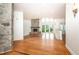 Bright living room with a stone fireplace, wood floors, and a wall of windows at 112 Lancaster Dr, Chapel Hill, NC 27517
