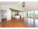 Spacious living area with hardwood floors, stone fireplace, custom cabinets, and scenic views from large windows at 112 Lancaster Dr, Chapel Hill, NC 27517