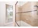 Ceramic tiled shower with glass door, and a window providing natural light at 112 Lancaster Dr, Chapel Hill, NC 27517