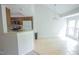 Open kitchen and dining area with tile flooring and ample natural light at 115 Abingdon Ct # 2B, Cary, NC 27513