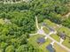 Aerial view of homes surrounded by dense trees in a serene neighborhood, offering privacy and natural beauty at 115 Jensen Dr, Wendell, NC 27591
