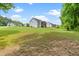 Large grassy backyard offering ample space for recreation and outdoor enjoyment with wooded backdrop at 115 Jensen Dr, Wendell, NC 27591