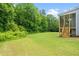 Expansive backyard featuring lush green grass and mature trees, perfect for outdoor activities and relaxation at 115 Jensen Dr, Wendell, NC 27591