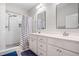 Modern bathroom with double vanity, white subway tile shower, and tile floors at 115 Jensen Dr, Wendell, NC 27591