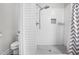 Clean bathroom with a tiled shower and built-in shelving at 115 Jensen Dr, Wendell, NC 27591