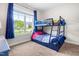Vibrant bedroom with bunk beds and a large window at 115 Jensen Dr, Wendell, NC 27591