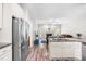 Modern kitchen with granite counters, stainless steel appliances, and an open view to the living room at 115 Jensen Dr, Wendell, NC 27591