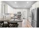 Bright kitchen featuring white cabinets, stainless steel appliances, and granite countertops at 115 Jensen Dr, Wendell, NC 27591