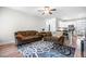 Inviting living room with plush sofas, a patterned rug, and plenty of natural light from the open floor plan at 115 Jensen Dr, Wendell, NC 27591