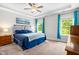 Spacious main bedroom featuring a tray ceiling, ceiling fan, and large windows at 115 Jensen Dr, Wendell, NC 27591