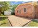Red brick house with a brick patio and a white outbuilding in the backyard at 1304 Park Ave, Dunn, NC 28334