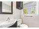 Light filled bathroom with gray walls and an updated mirror and sink at 1304 Park Ave, Dunn, NC 28334