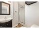 An updated full bathroom featuring a glass door shower and tile floors at 1304 Park Ave, Dunn, NC 28334
