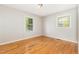 A light-filled bedroom featuring hardwood floors, offering a comfortable and serene living space at 1304 Park Ave, Dunn, NC 28334